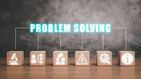 Problem solving concept, Wooden block on desk with problem solving icon on virtual screen.