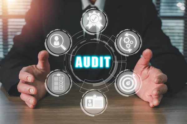Audit concept, Businessman hand holding audit icon on virtual screen,  income statement, balance sheet, cash flow statement.