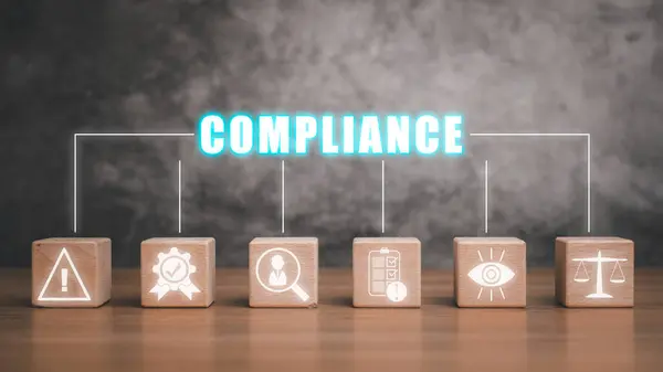 Compliance concept, Wooden block on wooden desk with compliance icon on virtual screen, laws, regulations, and standards, requirements, internal policies and procedures.