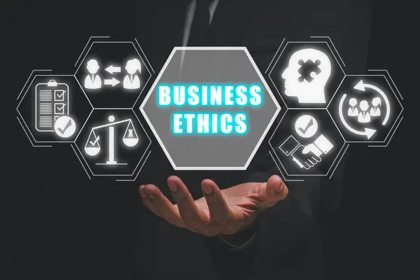 Business Ethics concept, Businessman hand holding business Ethics icon on virtual screen, Ethical corporate culture, business integrity and moral principles concept.