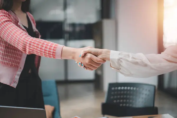 Business partnership meeting concept. Image business womans handshake. Successful businessmen handshaking after good deal.