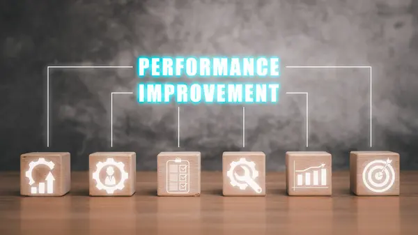 Performance Improvement concept, Wooden block on desk with performance improvement icon on virtual screen. Procedures, Productivity, Measuring, Efficiency, Qualification, Customers, Development.