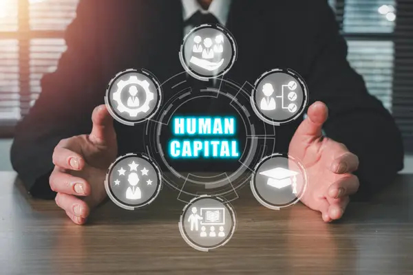 Human capital concept, Businessman hand holding human capital icon on virtual screen. Production Process, Employee, Know-How, Education, Skills, Knowledge, Health, Earnings.