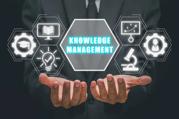 Knowledge management concept, Businessman hand holding knowledge management icon on virtual screen.