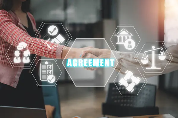 Agreement concept, Successful businessmen handshaking after good deal with agreement icon on virtual screen.