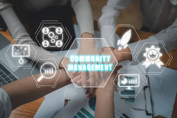 Community management concept, Positive diverse business team putting their hands on top of each other with community management icon on virtual screen.