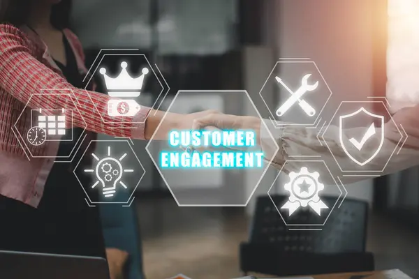 Customer engagement concept, Handshake between two businesswomen with customer engagement icon on virtual screen.
