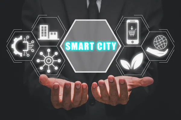 Smart city concept, Businessman hands holding smart city icon on virtual screen.