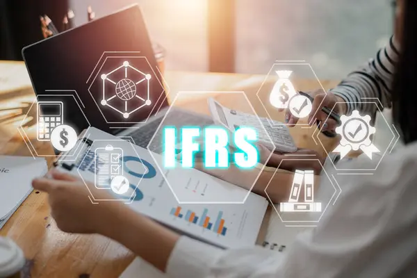 IFRS, International Financial Reporting Standards concept, Business team analyzing income charts and graphs with International Financial Reporting Standards icon on virtual screen.