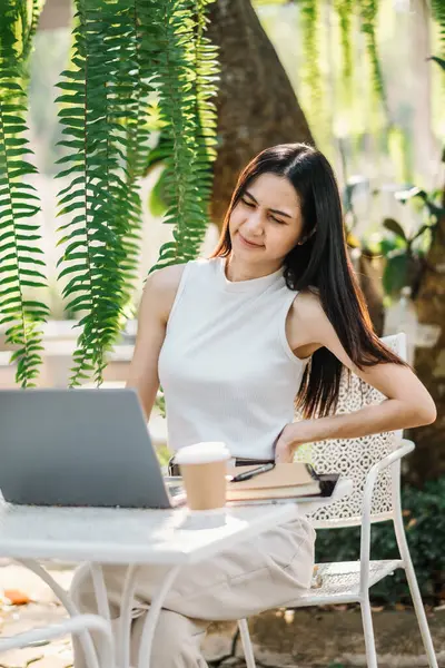 Young Woman Expresses Frustration While Working Laptop Outdoor Table Surrounded Royalty Free Stock Photos