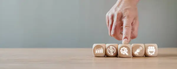 stock image Value chain concept, Hand holding wooden block on desk with value chain icon on virtual screen.
