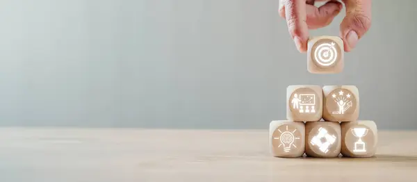 stock image Mentoring concept, Hand holding wooden block on desk with Mentoring icon on virtual screen.