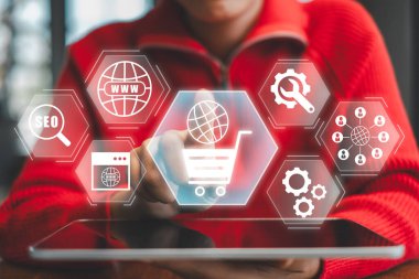 Dijital simgelerle ve tabletle e-ticaretin görsel temsili, online alışveriş teknolojisi sergileniyor.