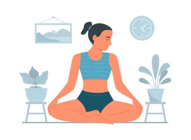 Yoga yapan kadın evde meditasyon yapıyor.