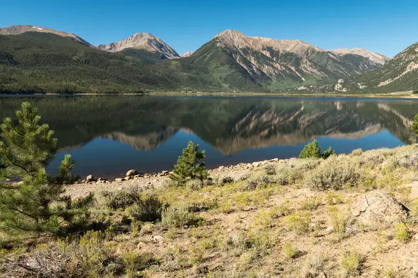 Reflections of 13,468 Foot Quail Mountain, 13,939 Foot Mount Hope, 13,290 & 13,333 Foot Twin Peaks, with 13,783 Foot Rinker Peak rise above the Twin Lakes in Central Colorado.
