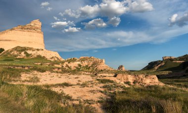 Looking east is Eagle Rock which was used as a landmark to the early pioneers on there way west. Mitchell pass is where the Oregon Trail crosses between Eagle Rock and Sentinel Rock.  clipart