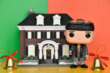 Funko Pop action figure of burglar Harry against McCallister Home from comedy film Home Alone. Christmas bells, colorful gift wrappers. clipart