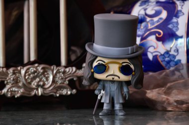 Funko Pop action figure of Bram Stoker's Dracula vampire prince Vlad. Dark ancient palace with columns, vintage blue keg, moody background, reflection. clipart