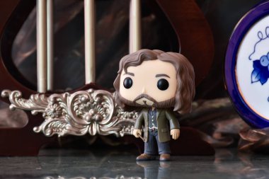 Funko Pop action figure of wizard Sirius Black from popular fantasy movie Harry Potter. Dark ancient palace with columns, vintage porcelain blue keg. clipart