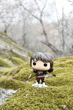 Korku dizisi Stranger Things 'ten Eddie Munson' ın funko pop aksiyon figürü. Yeşil yosunlu kayalar, vahşi orman, vadi, atmosferik yer. 