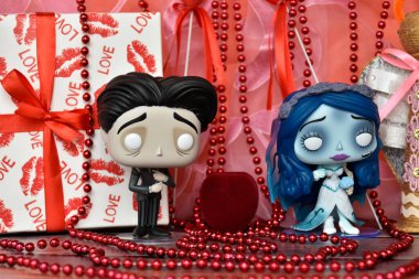 Funko Pop action figures of Victor and Emily from gothic animated film Corpse Bride. Valentine's Day, handmade angel, gift box, red ribbons, hearts, romance.