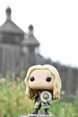 Eowyn 'in Funko Pop aksiyon figürü, Rohan' ın asil kadını, Yüzüklerin Efendisi adlı fantezi filmindeki bakire. Eski ahşap kale kuleleri, yüksek kapılar.