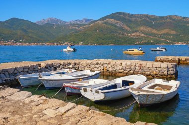 Beautiful autumn Mediterranean landscape. Montenegro, Adriatic Sea. Fishing boats in stone jetty. Mandrac ( mandrach ) , cultural heritage of Kotor Bay