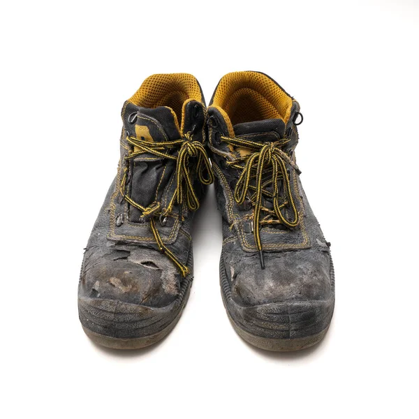 old worn out work shoes. isolated white background