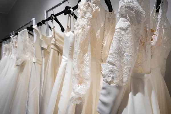 wedding dresses hanging in a row