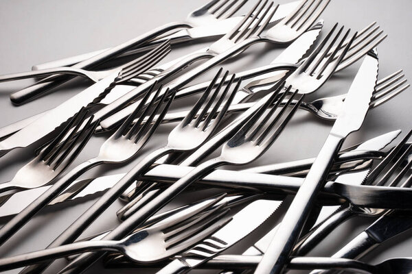 group of forks and knives on a white background. Selective focus