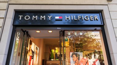 İspanya, Barselona - 3 Mayıs 2023: Tommy Hilfiger marka tabela dükkan penceresinin üzerinde
