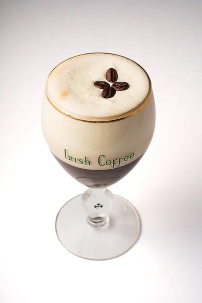 Irish coffee is a famous Irish drink made from coffee and whiskey, with cream on top. White background