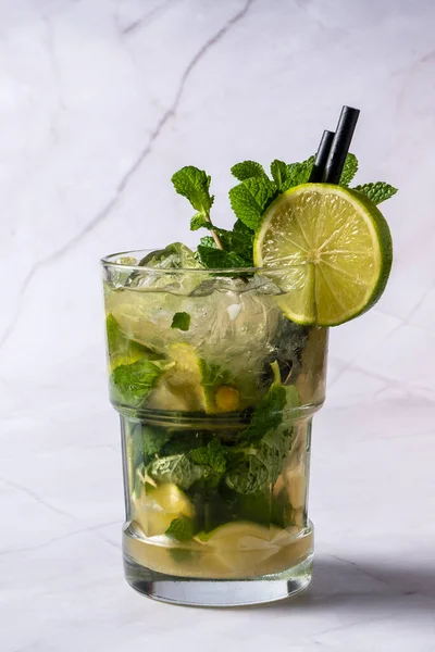 Mojito aperitif with white rum, mint leaves, lime, brown sugar, soda and ice