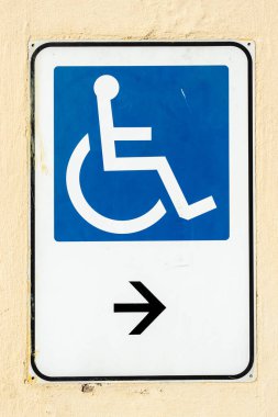 Duvarda asılı engelli giriş işareti