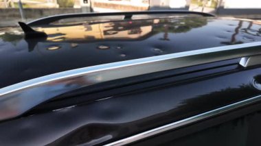 Hasarlı arabanın çatısı dolu. Metal yüzeyde doğal ışık altında görünen göçükler var..