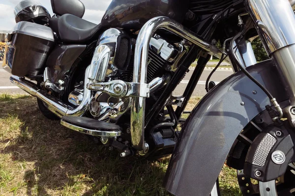 black motorcycle side view close-up ,motorcycle standing on green grass isolated,close-up view. High quality photo