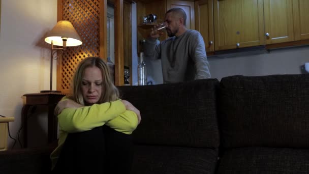 Zdenerwowana Kobieta Stojąca Ręcznikiem Kuchni Płacząca Pijany Człowiek Siedzi Tyłu — Wideo stockowe