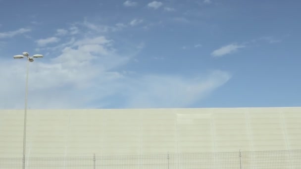 Weißes Gebäude Vor Weißen Wolken Und Blauem Himmel Hintergrund Draufsicht — Stockvideo