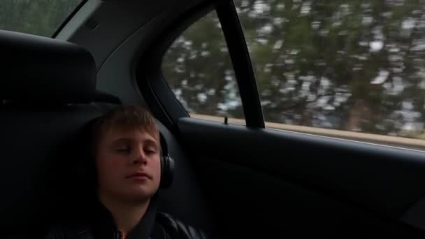 Een Tienerjongen Rijdt Achterbank Van Een Auto Maakt Zijn Gordel — Stockvideo
