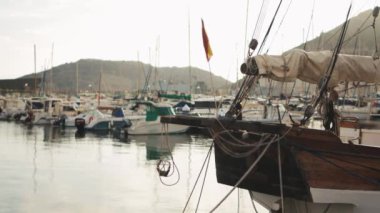 Körfezde tek kişilik küçük bir yat. Yatlar ve botlar arka planda 4K. Yüksek kalite 4k görüntü