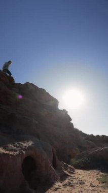 young man with a dog in the desert