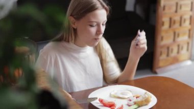 Kız çatalla tatlı yiyor.