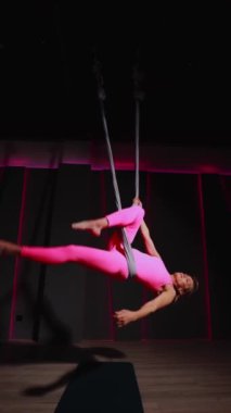 Güzel kadın sporcu, spor salonu hobisi olan etek giysisi yogasında havada tüy döküyor. Yüksek kaliteli FullHD görüntüler