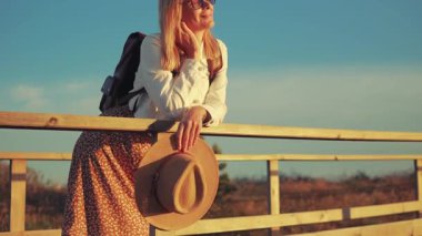 Deniz arka plan üzerinde bir sırt çantası ile kız