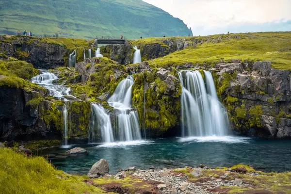 Sunset at famous Kirkjufellsfoss waterfall and Kirkjufell mounta