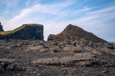 Breathtaking view of Valahnkaml Bay with steep cliffs and lava rocks in southern Iceland clipart