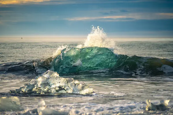Güneşin doğuşuyla birlikte Jkulsrln yakınlarındaki buzul plajındaki eriyen buzuldan bir buz kütlesinin yakınına İzlanda 'daki Vatnajkull Ulusal Parkı' na.