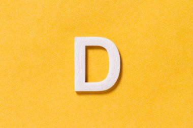 Letter D of the alphabet isolated on yellow background, top view