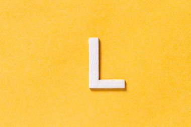 Letter L of the alphabet isolated on yellow background, top view