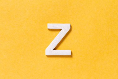 Letter Z of the alphabet isolated on yellow background, top view